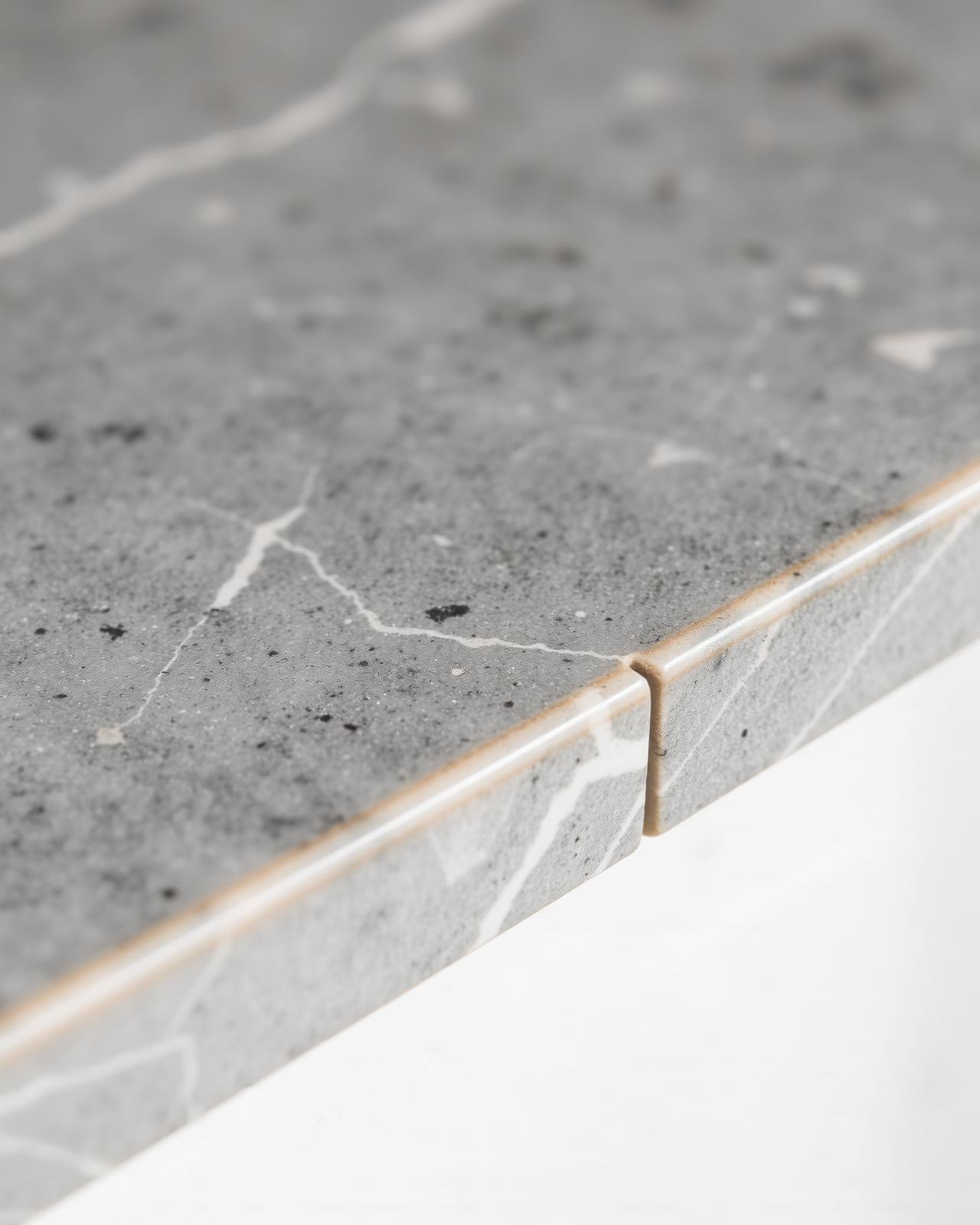 Macro detail of honed grey marble edge